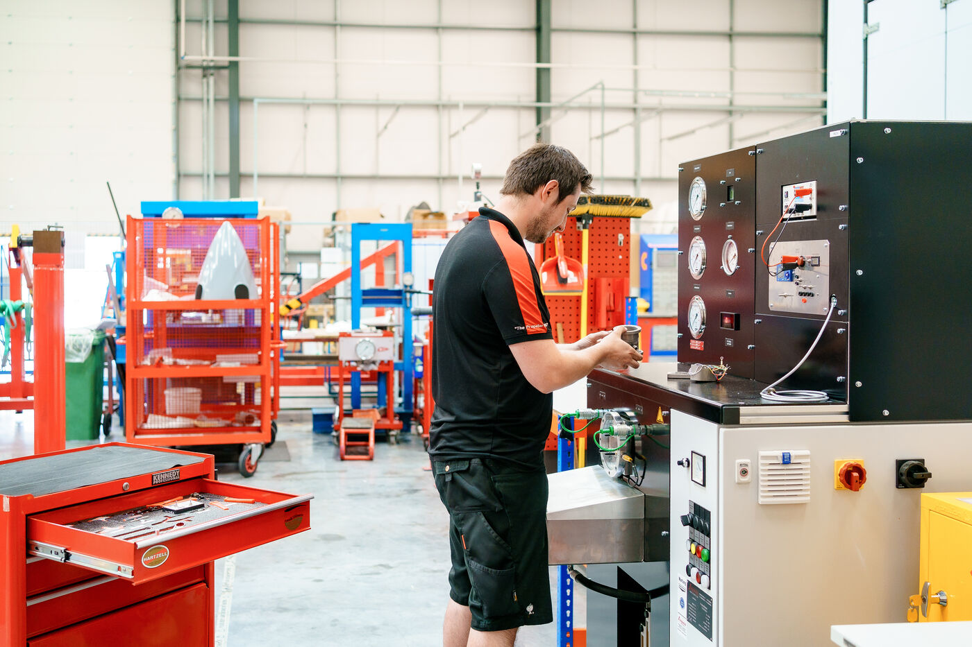 ROKK engineer operating the propeller governor test bench