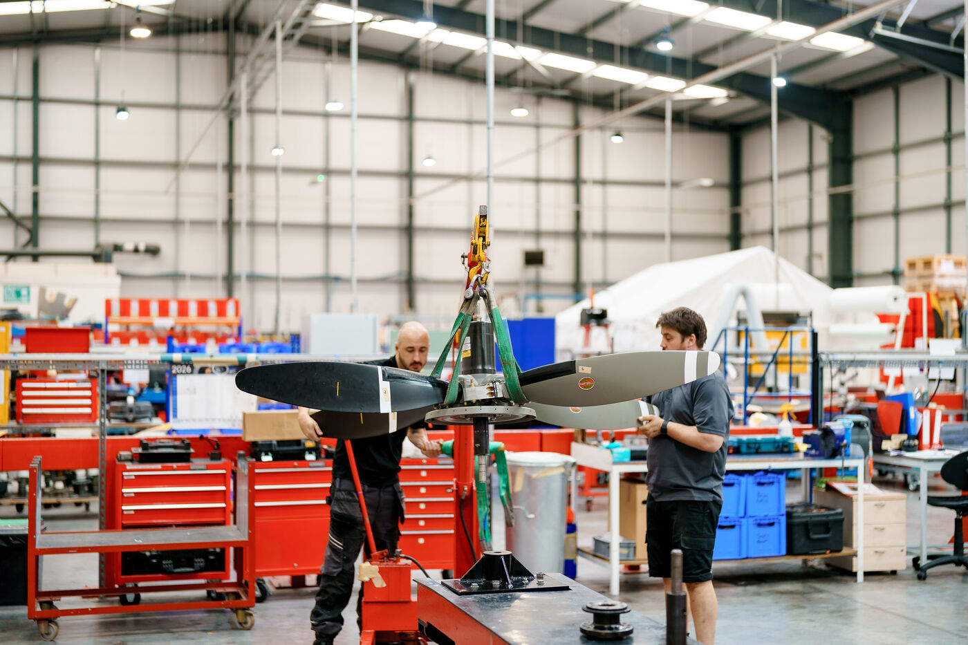 ROKK engineers fitting blades to a propeller hub in the workshop